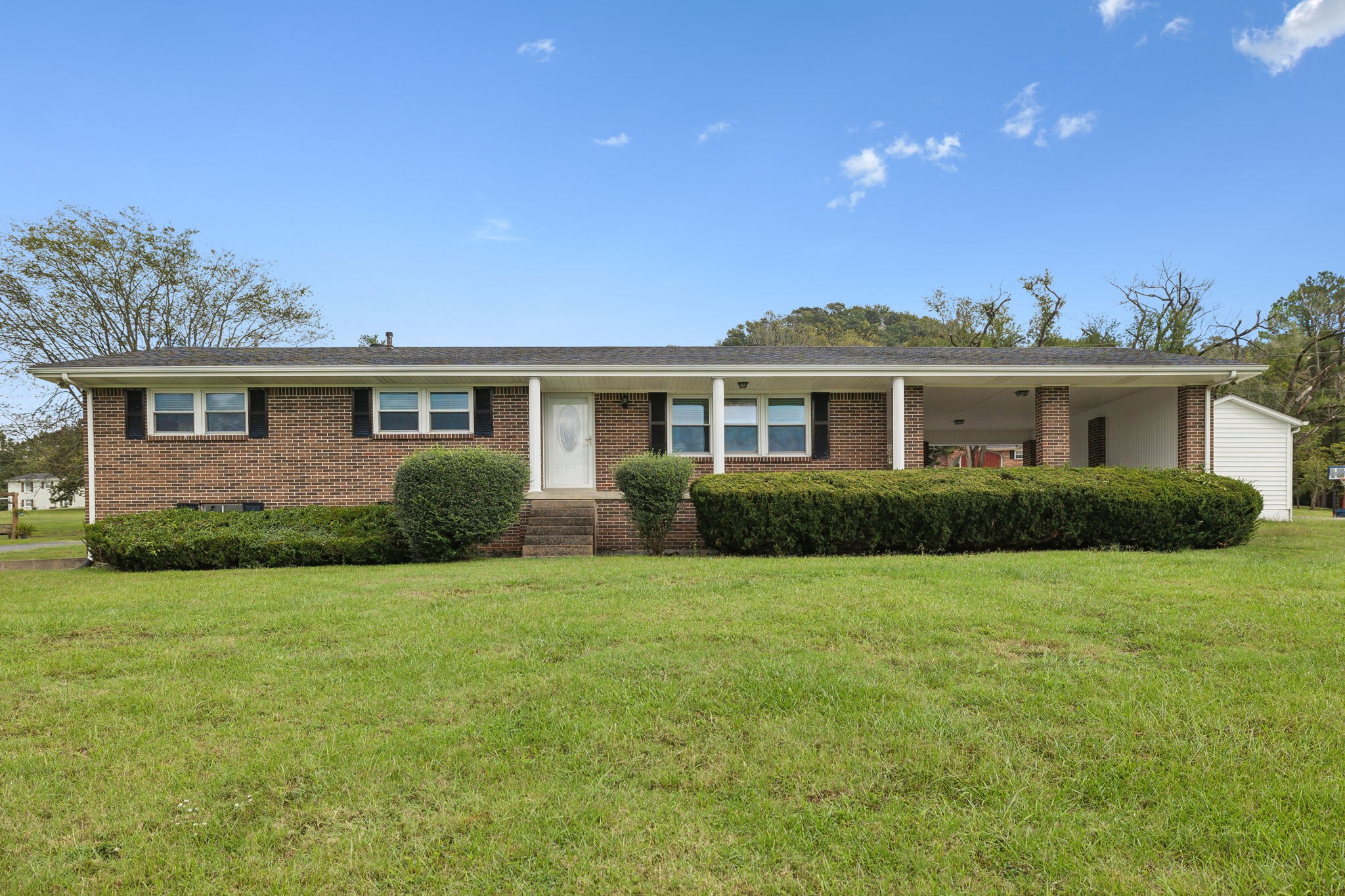 a front view of a house with a garden