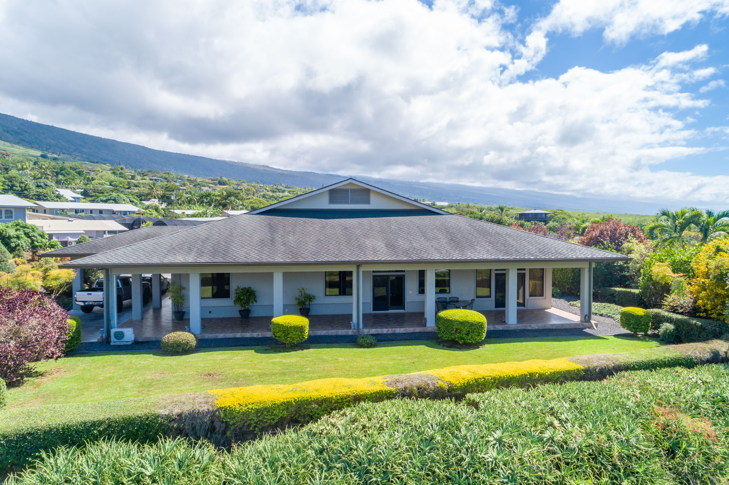 a view of a house with a swimming pool and a yard