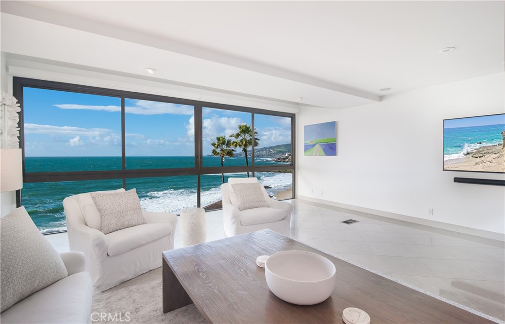 a living room with furniture and a floor to ceiling window