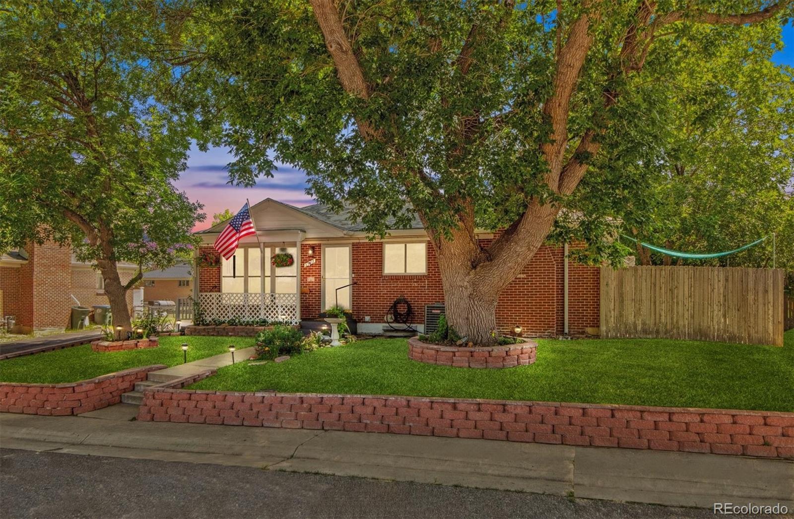 a front view of a house with a yard and a garage