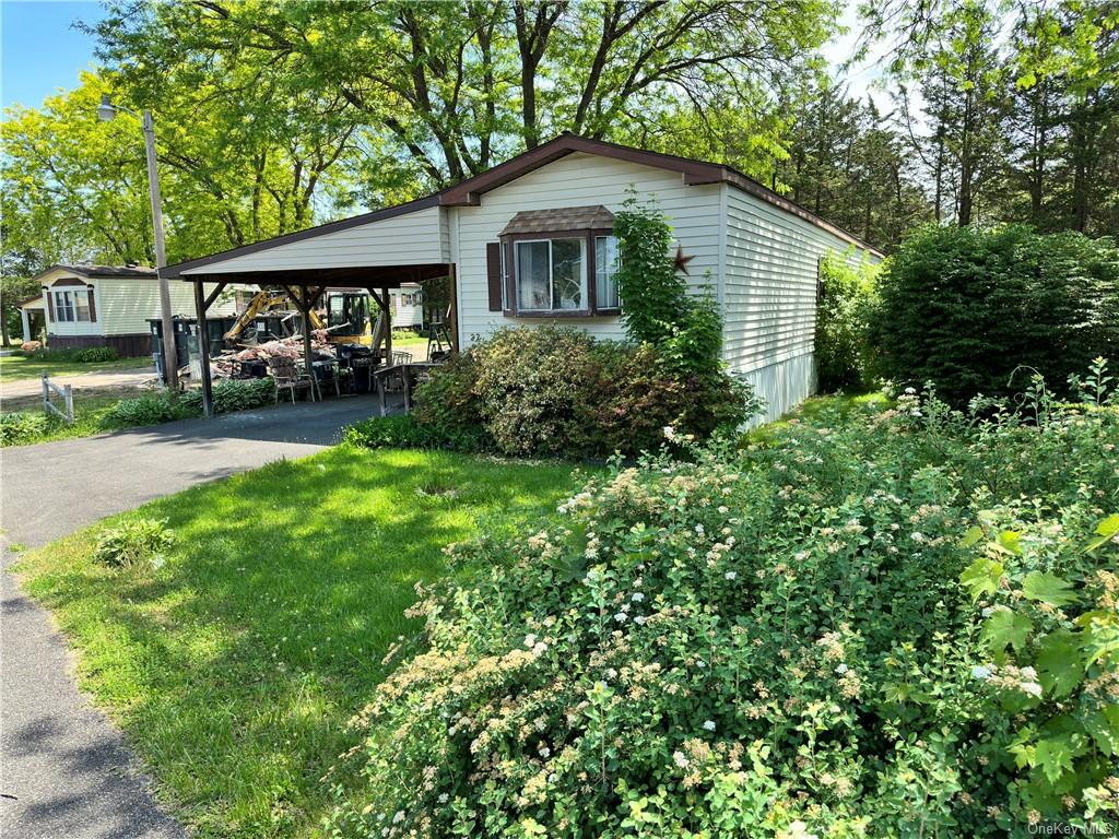 a front view of a house with yard and green space