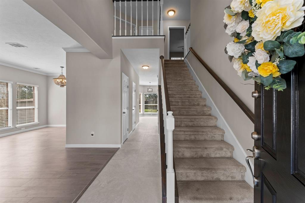 a view of entryway and hall with wooden floor