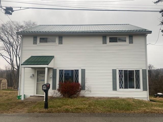 a front view of a house with a yard