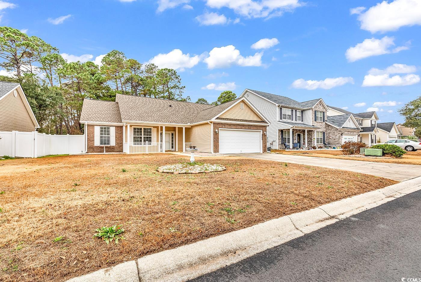 View of front of house with a garage and covered p