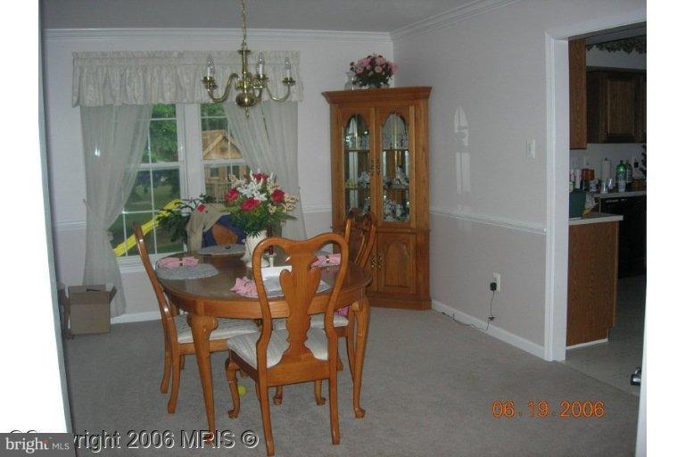 a view of a dining room with furniture and a chandelier