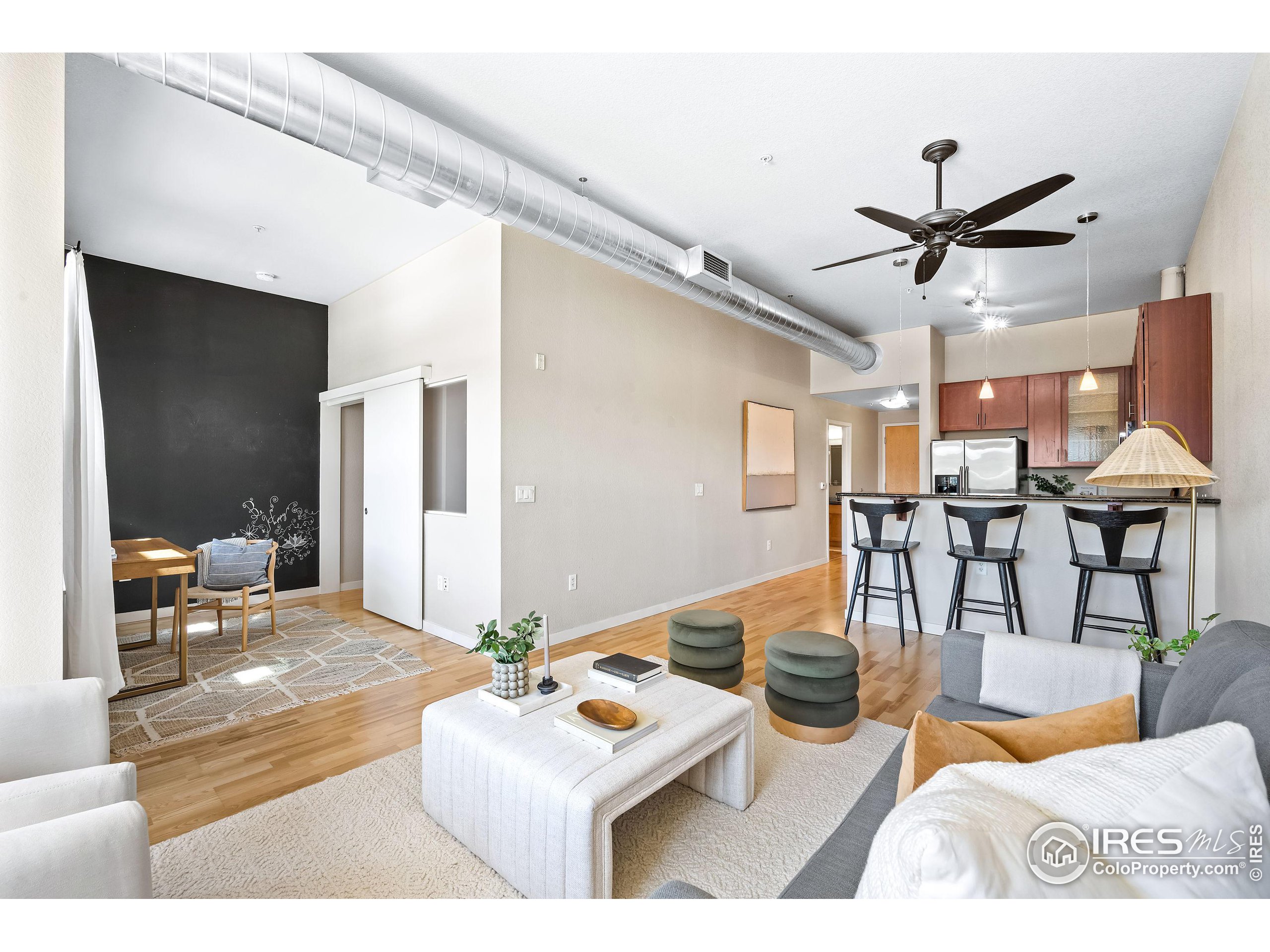 a living room with furniture and view of kitchen