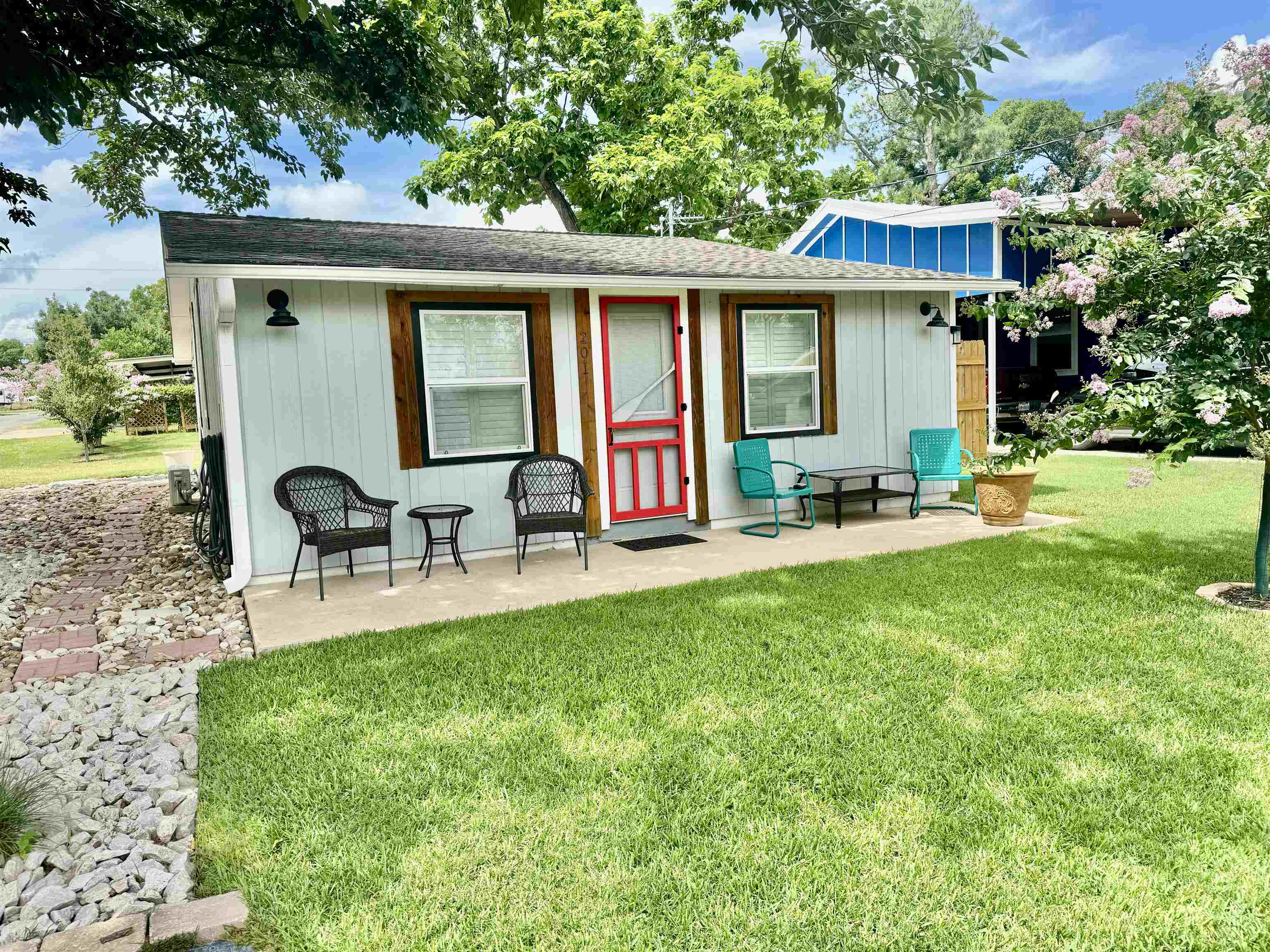 a view of a house with a yard patio and swimming pool