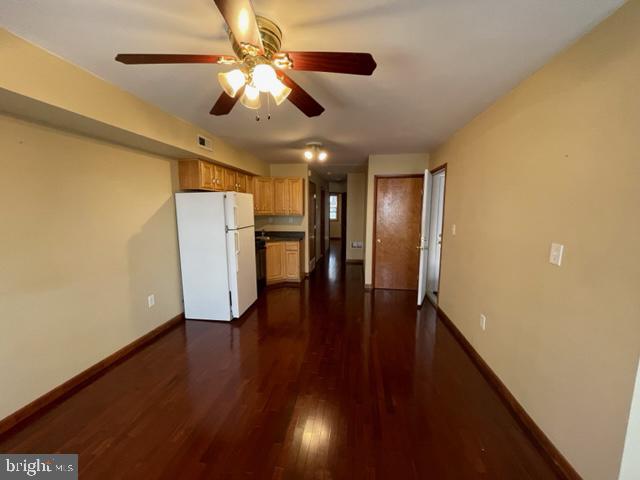 a view of a livingroom with a ceiling fan and wooden floor