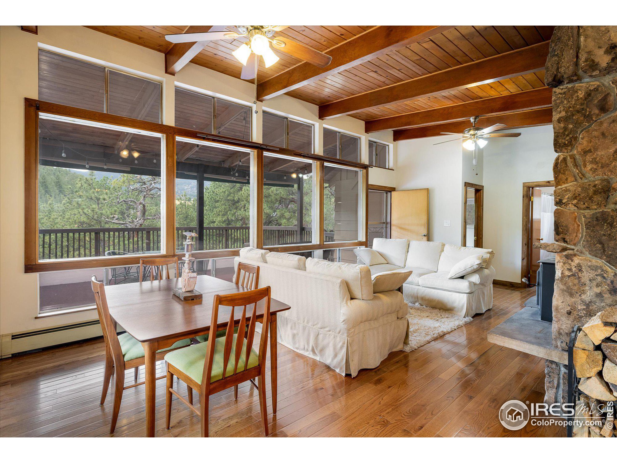 a dining room with furniture and wooden floor