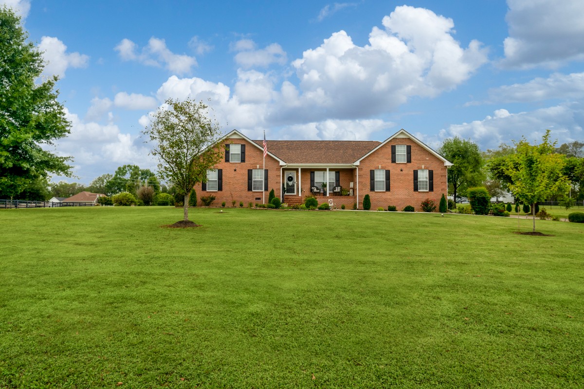 a front view of a house with garden