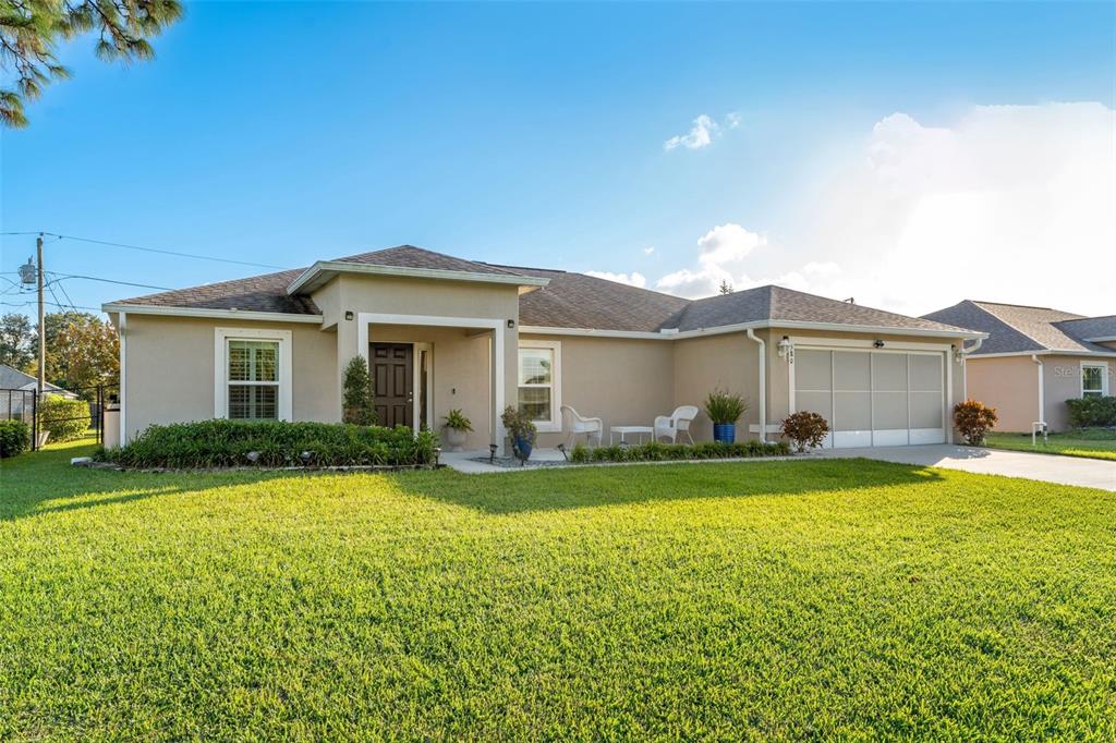 a front view of a house with a yard and garage