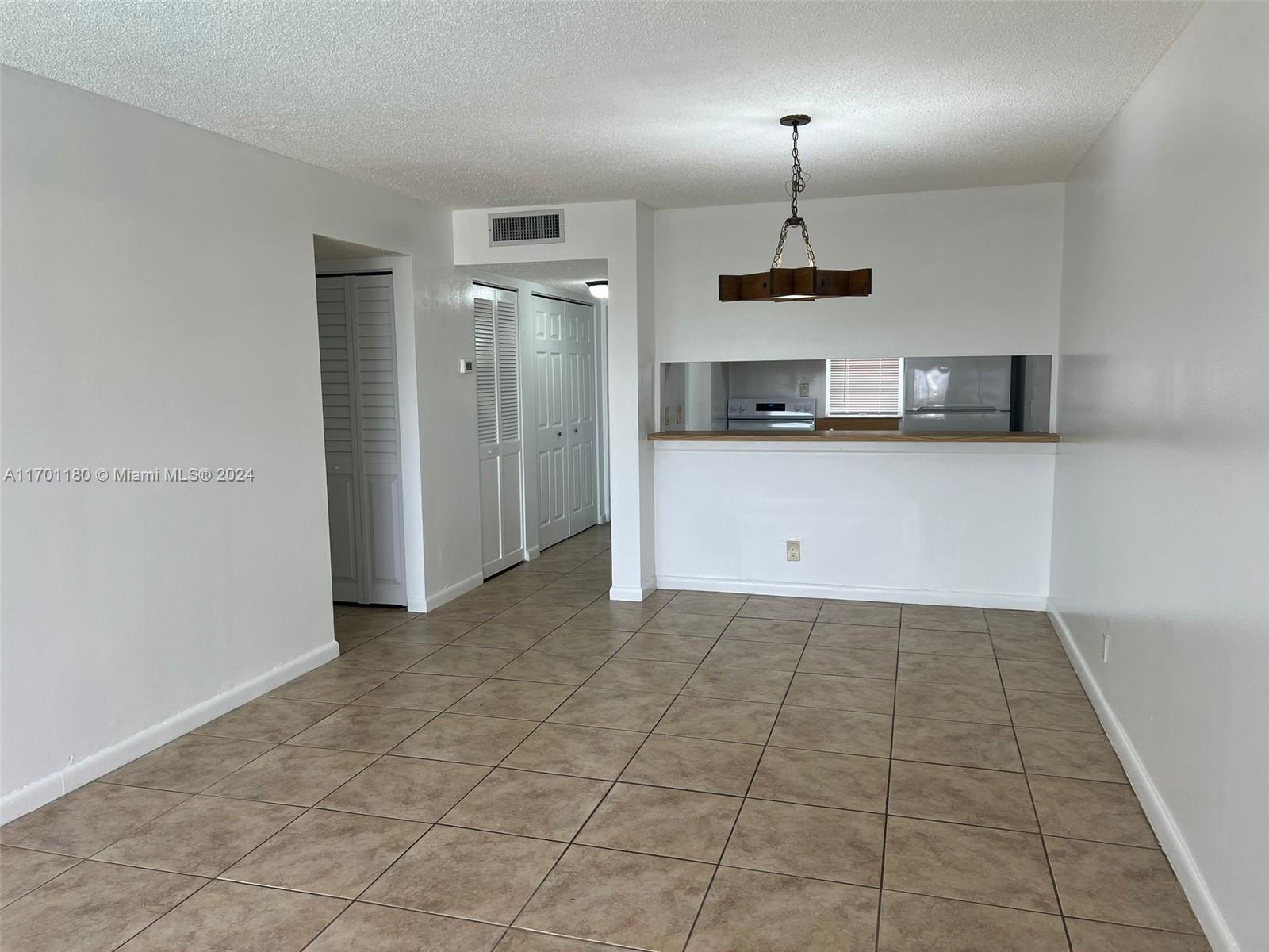 a kitchen with kitchen island a counter top space and cabinets