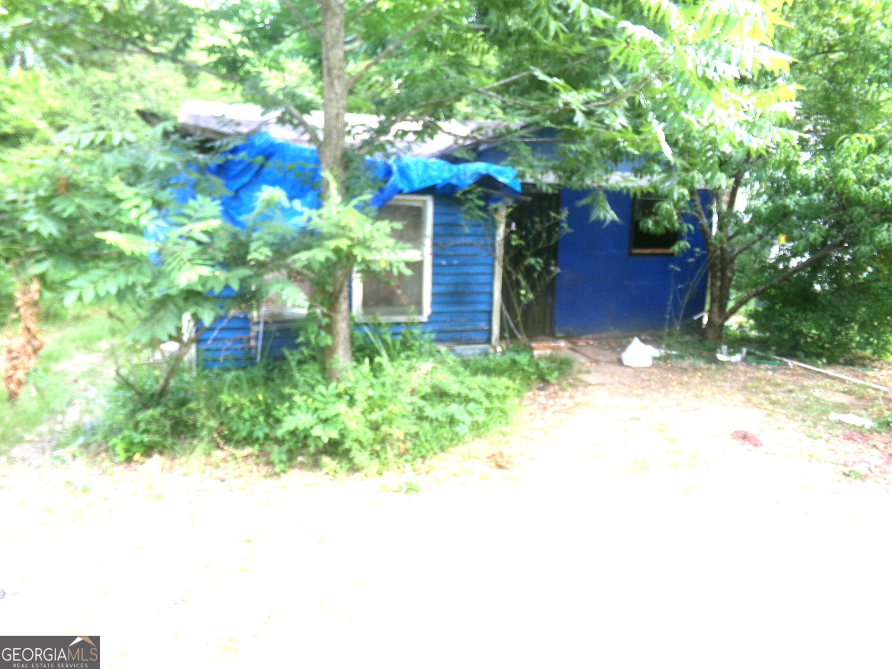 a yellow house with trees in front of it