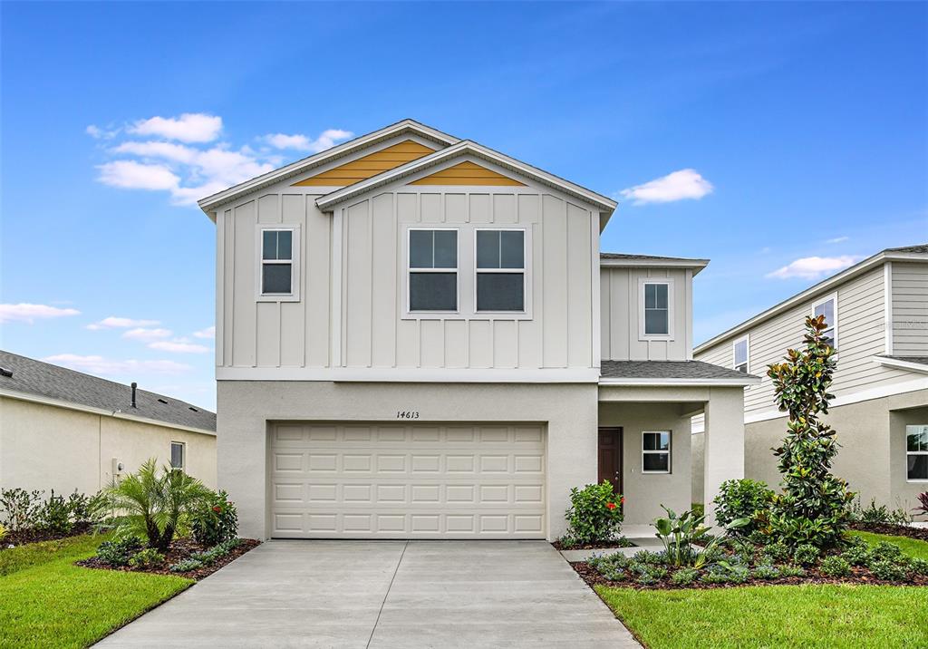 a front view of a house with a yard and garage