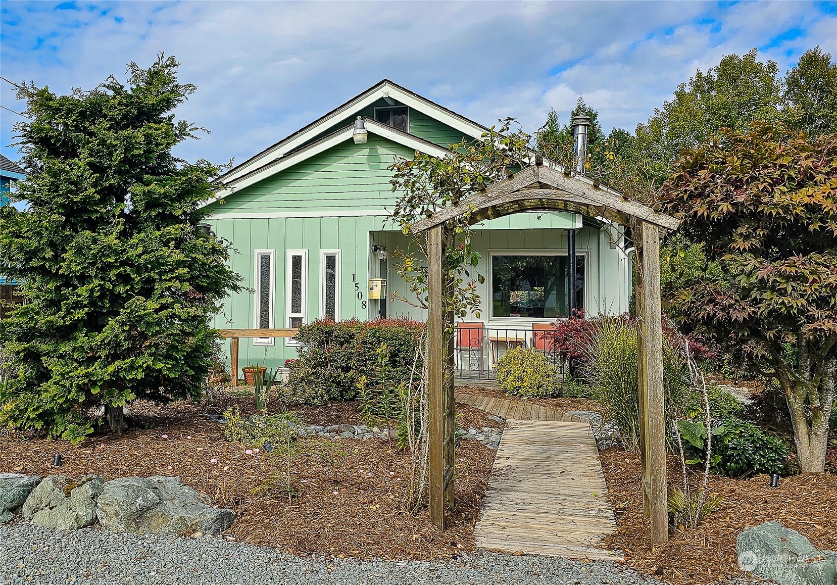 a front view of a house with garden