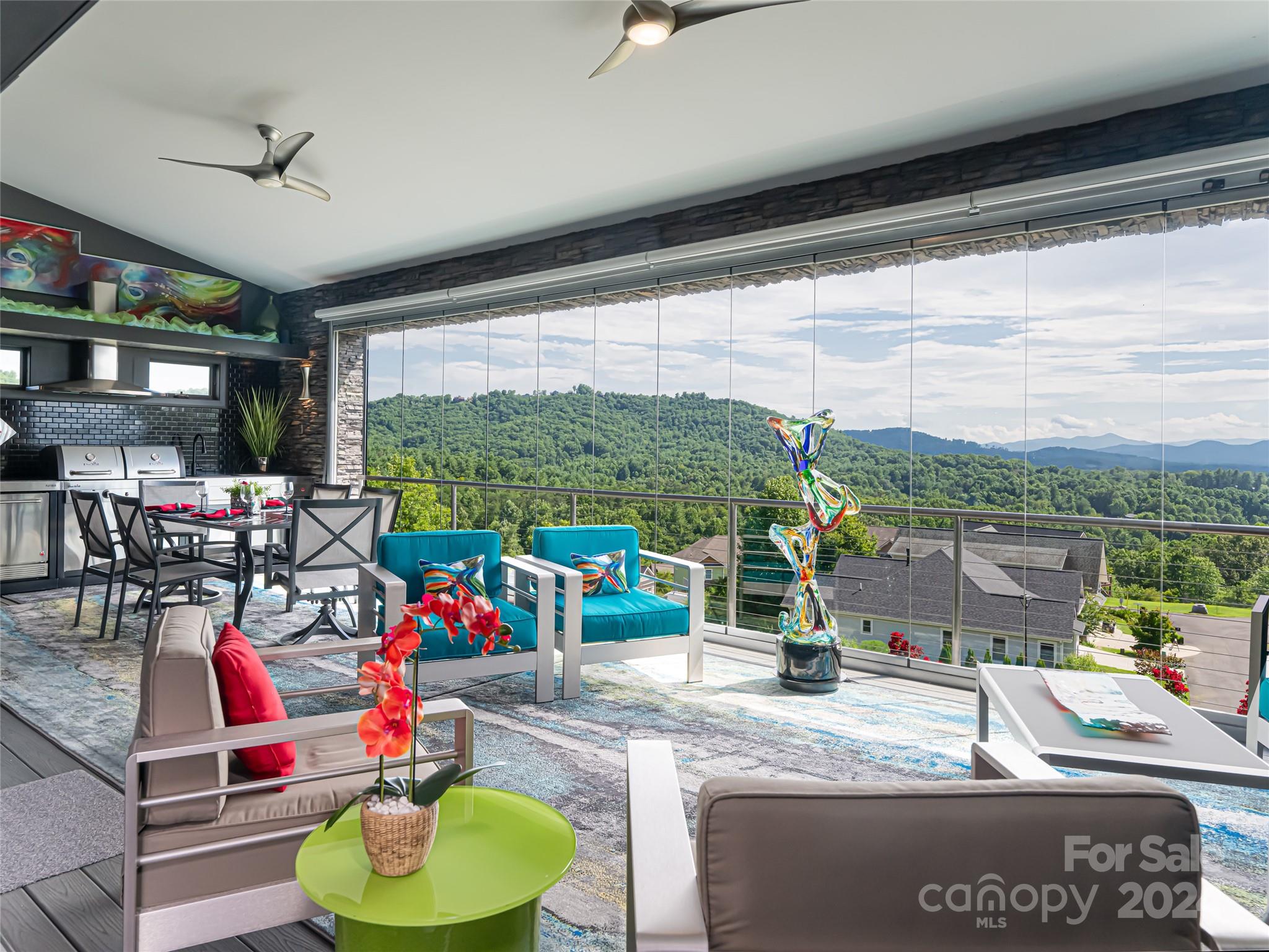 a living room with patio furniture and a floor to ceiling window