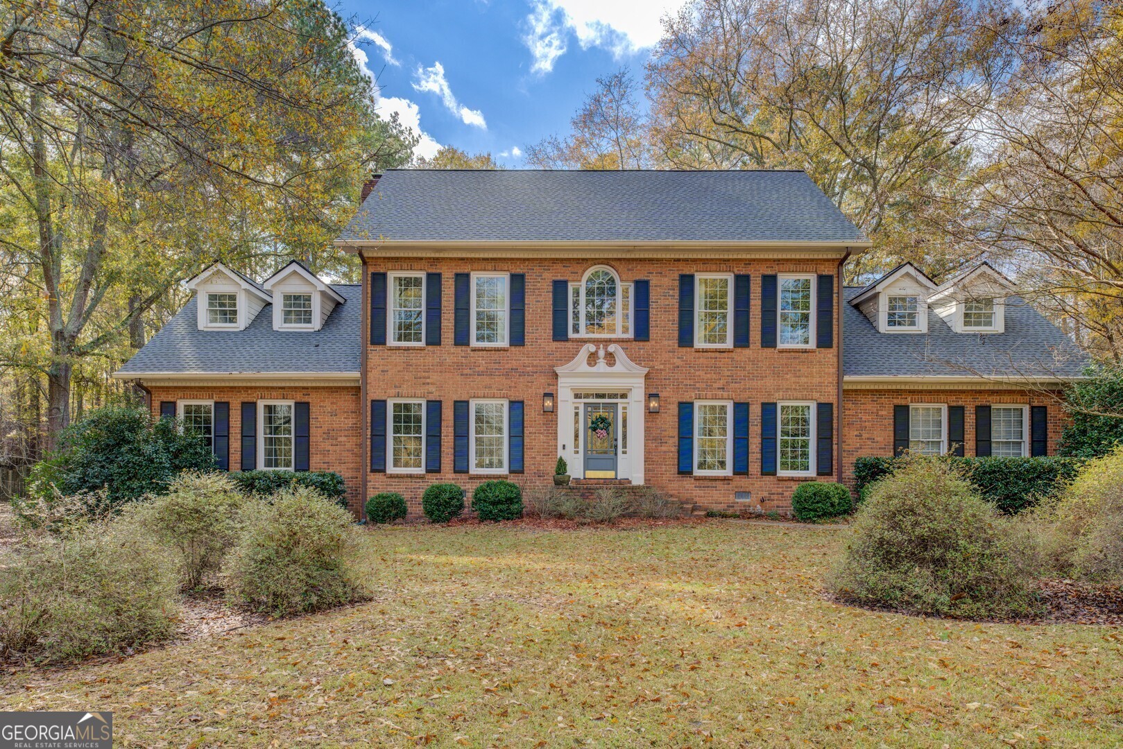 a front view of a house with garden