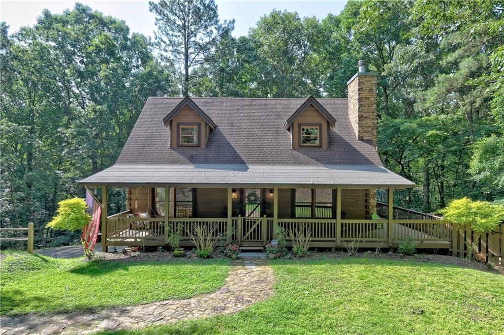 a front view of a house with a yard table and chairs