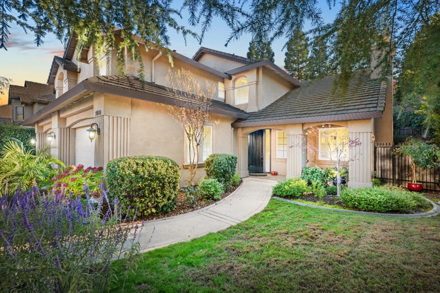 a front view of a house with garden