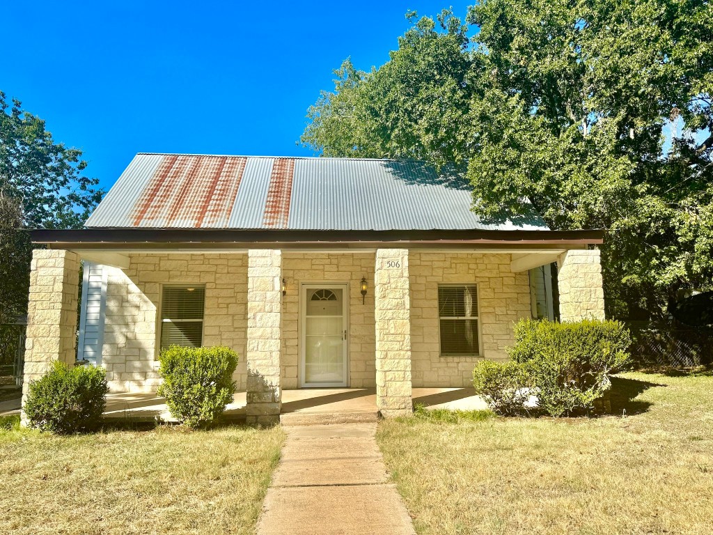 a view of house with backyard