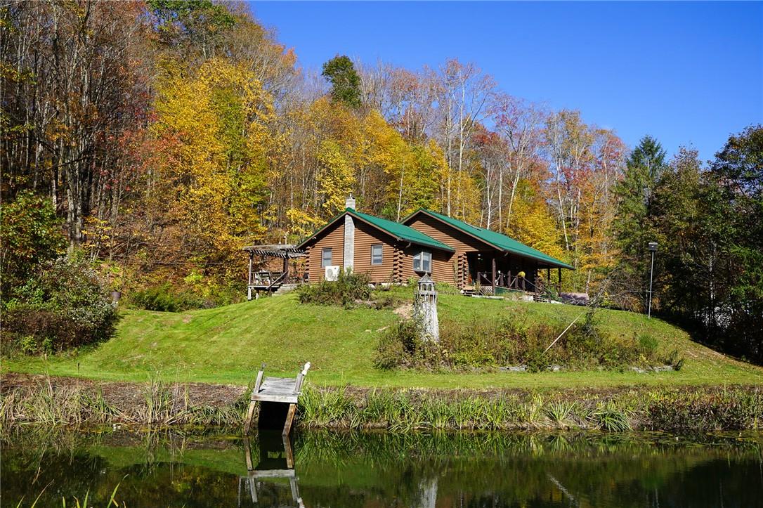 a house with green field in front of it