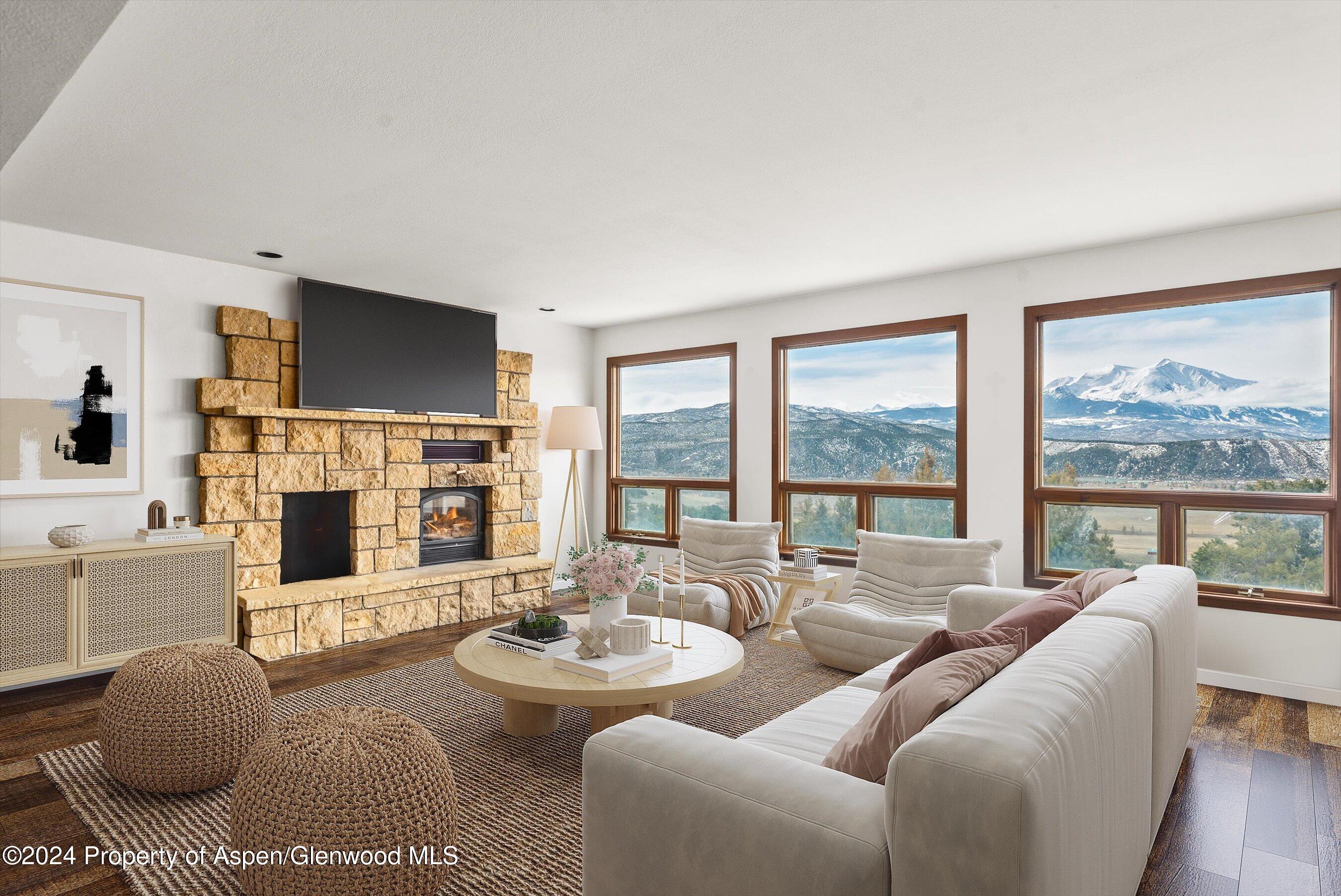 a living room with fireplace furniture and a large window