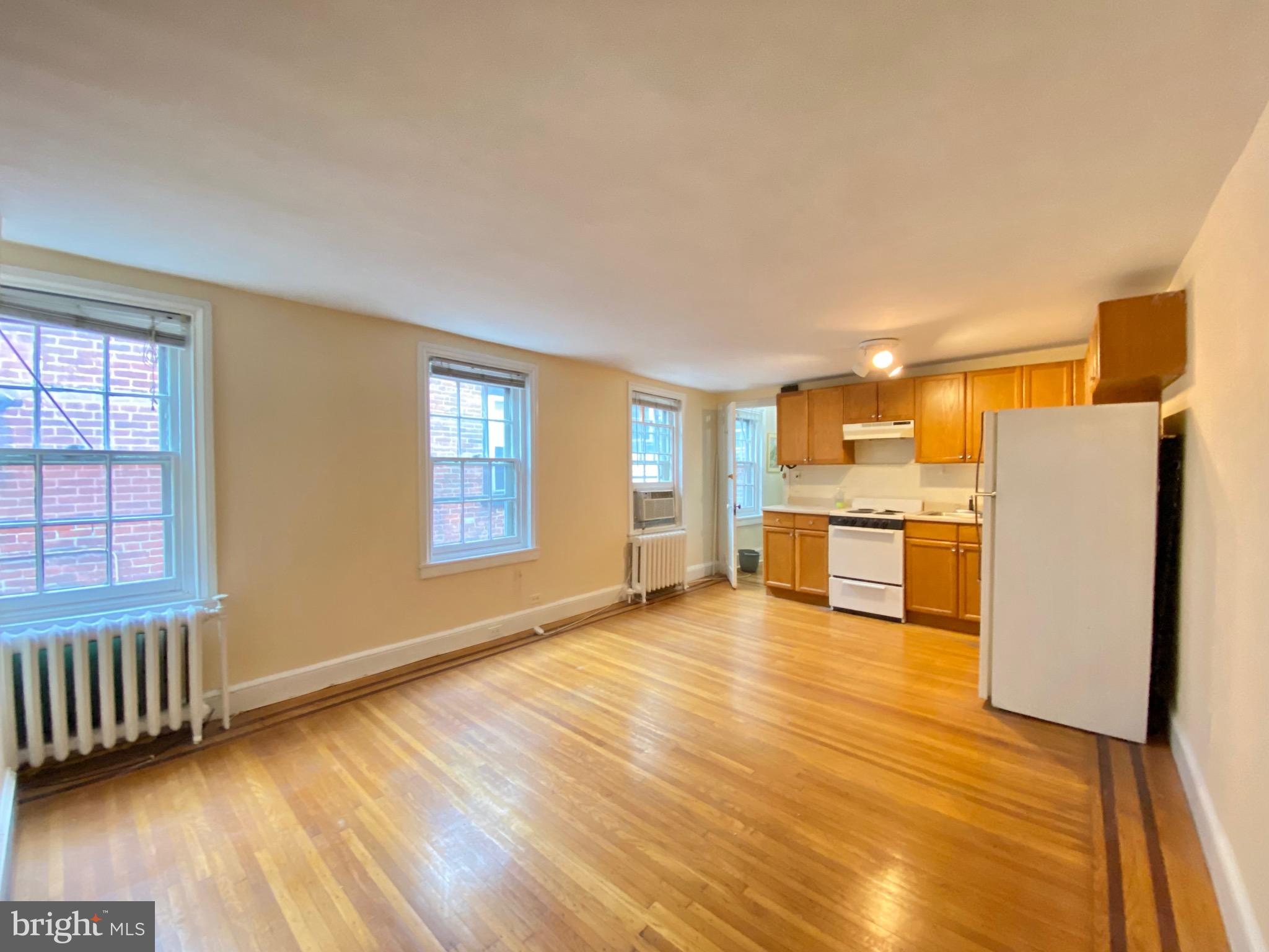 a view of a kitchen with microwave and refrigerator