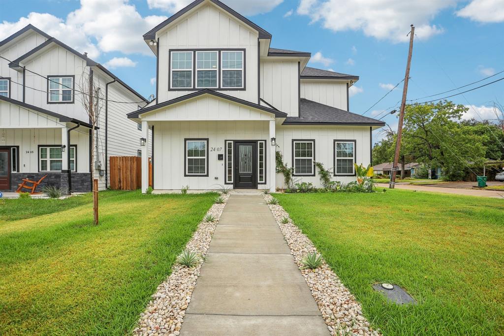 a front view of a house with a garden and yard