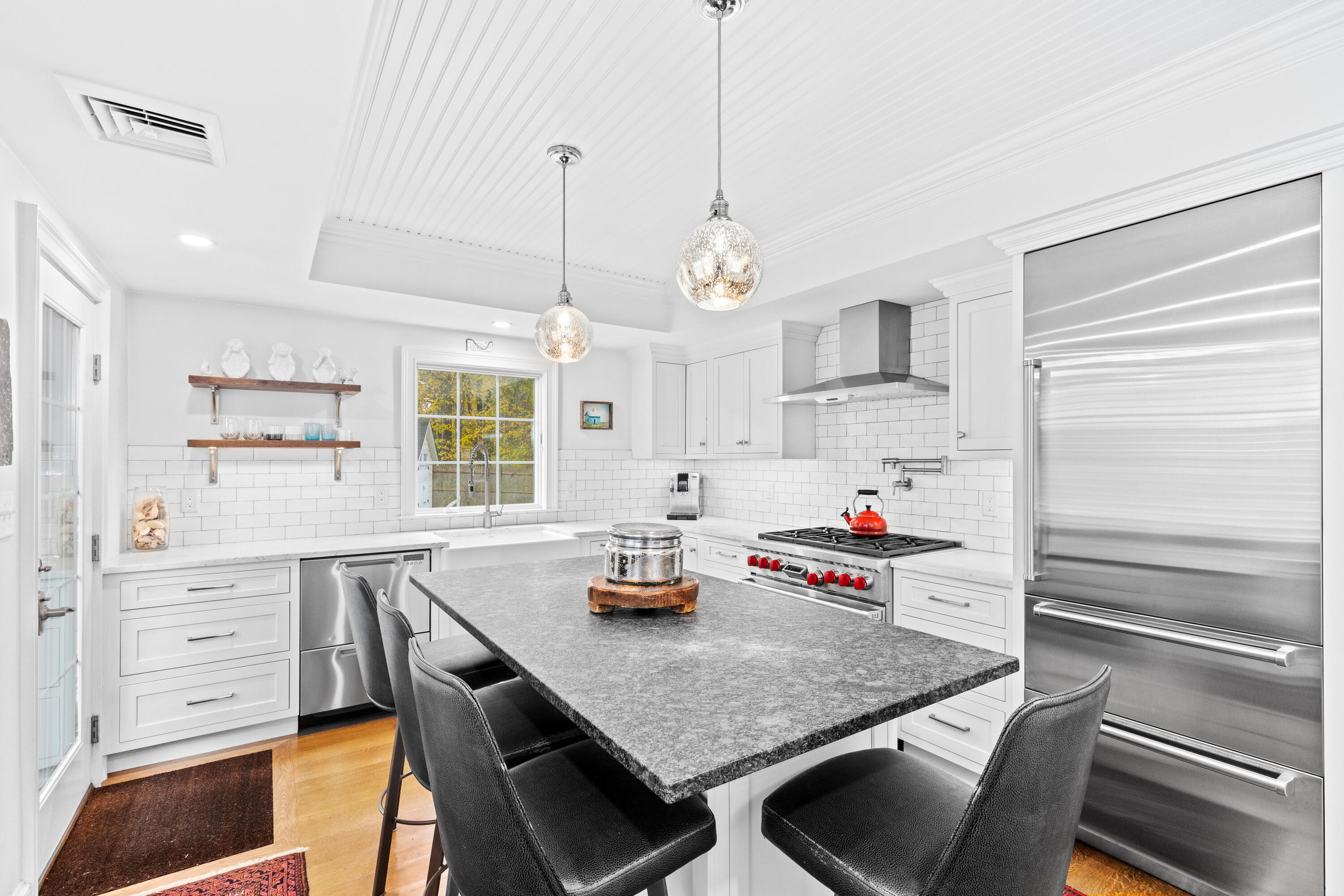 a kitchen with a table chairs and cabinets