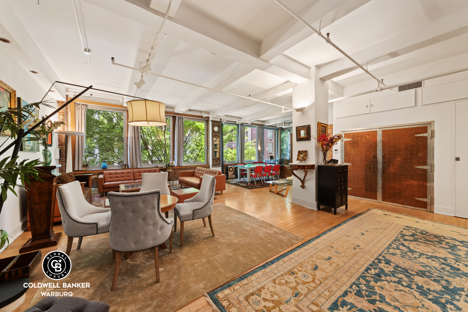 a living room with furniture a flat screen tv and a floor to ceiling window