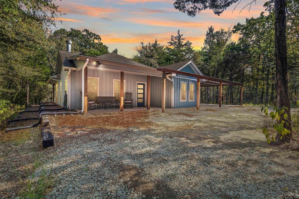 a backyard of a house with yard and outdoor seating