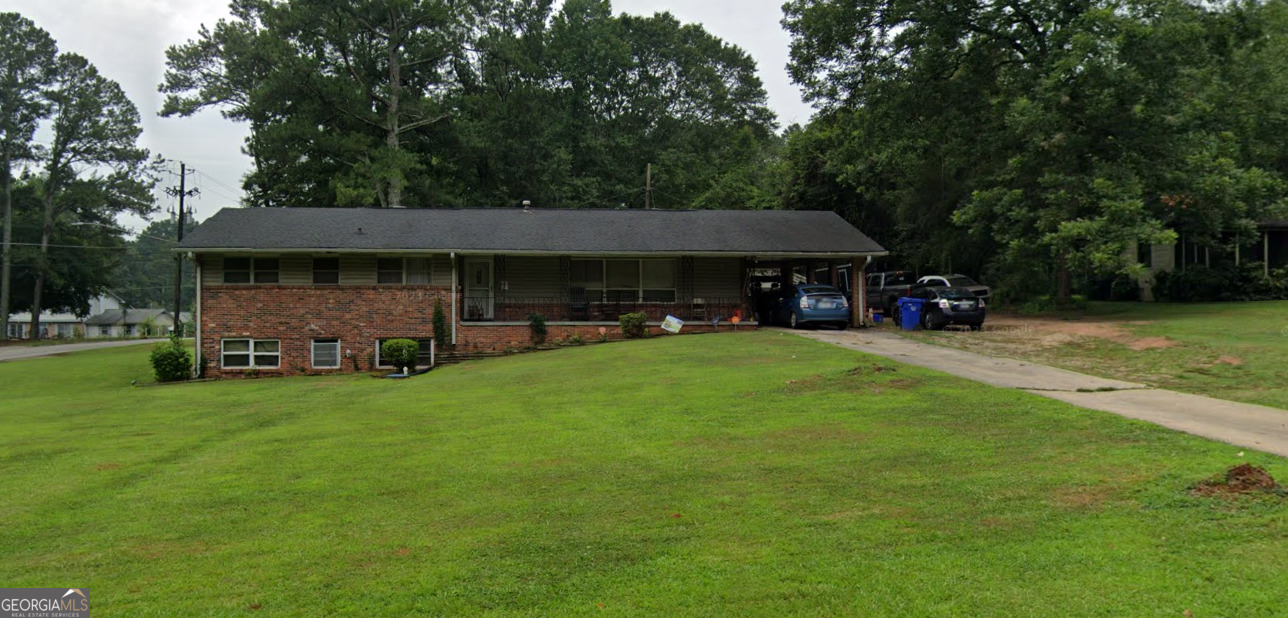 a view of a house with a yard porch and sitting area