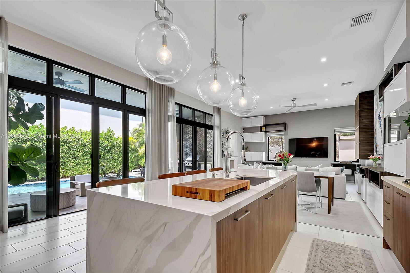 a kitchen that has a lot of cabinets a sink and a wooden floor