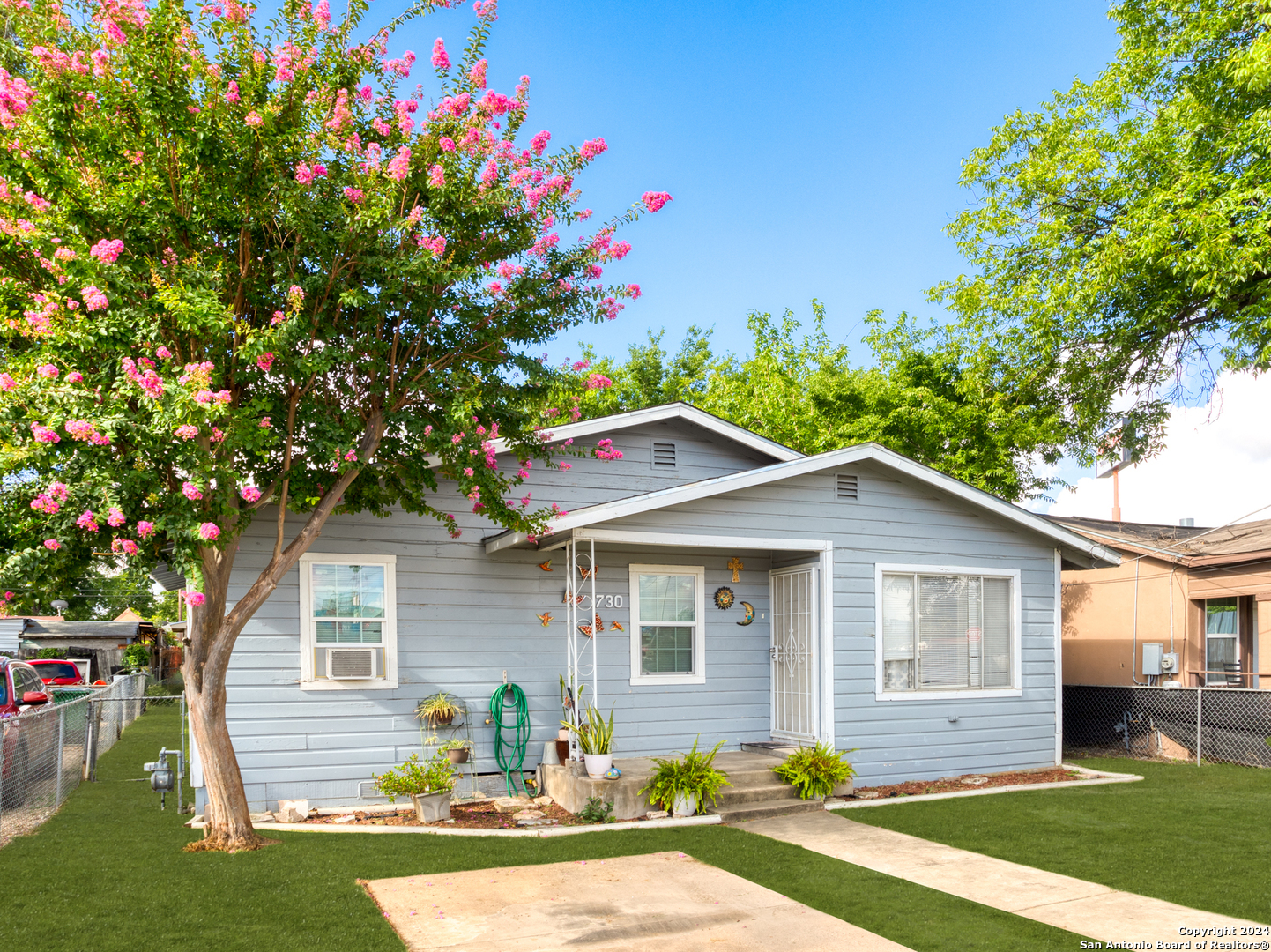 a front view of house with yard and green space