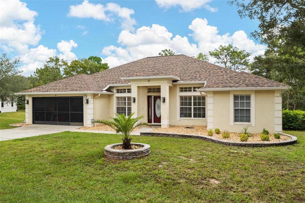 a front view of a house with a yard and garage