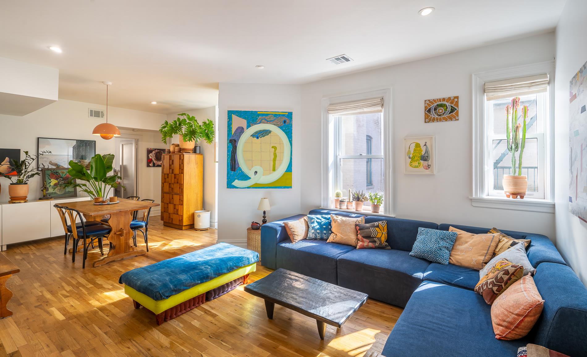 a living room with furniture and wooden floor