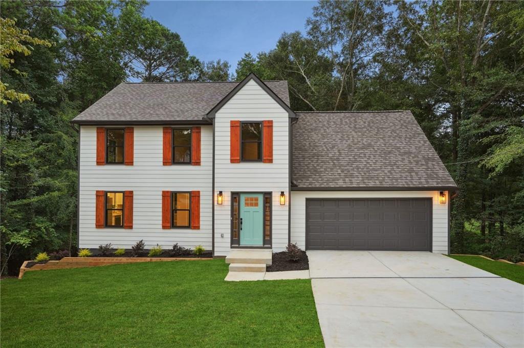 a front view of a house with a yard and garage