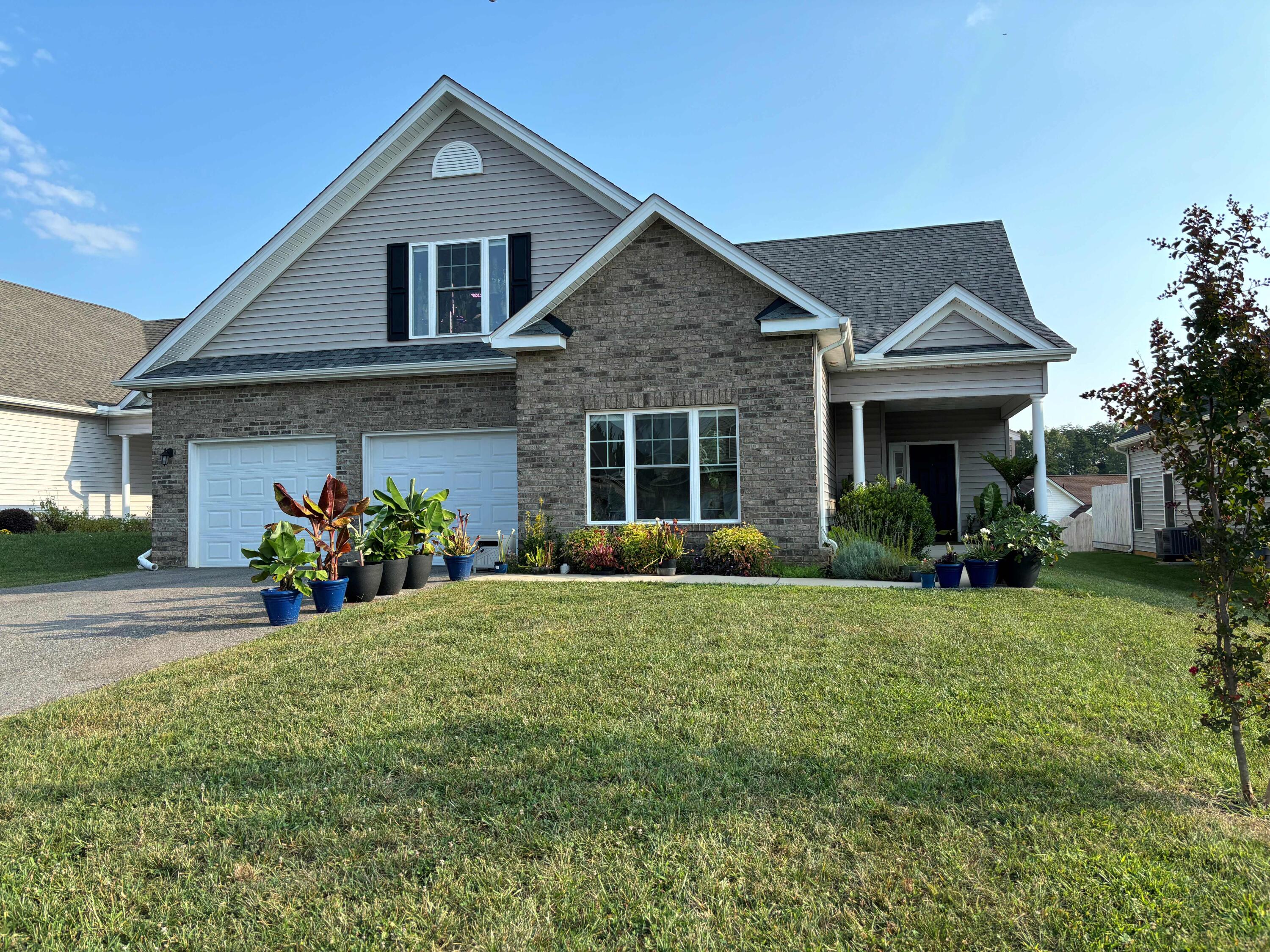 a front view of a house with a yard and porch