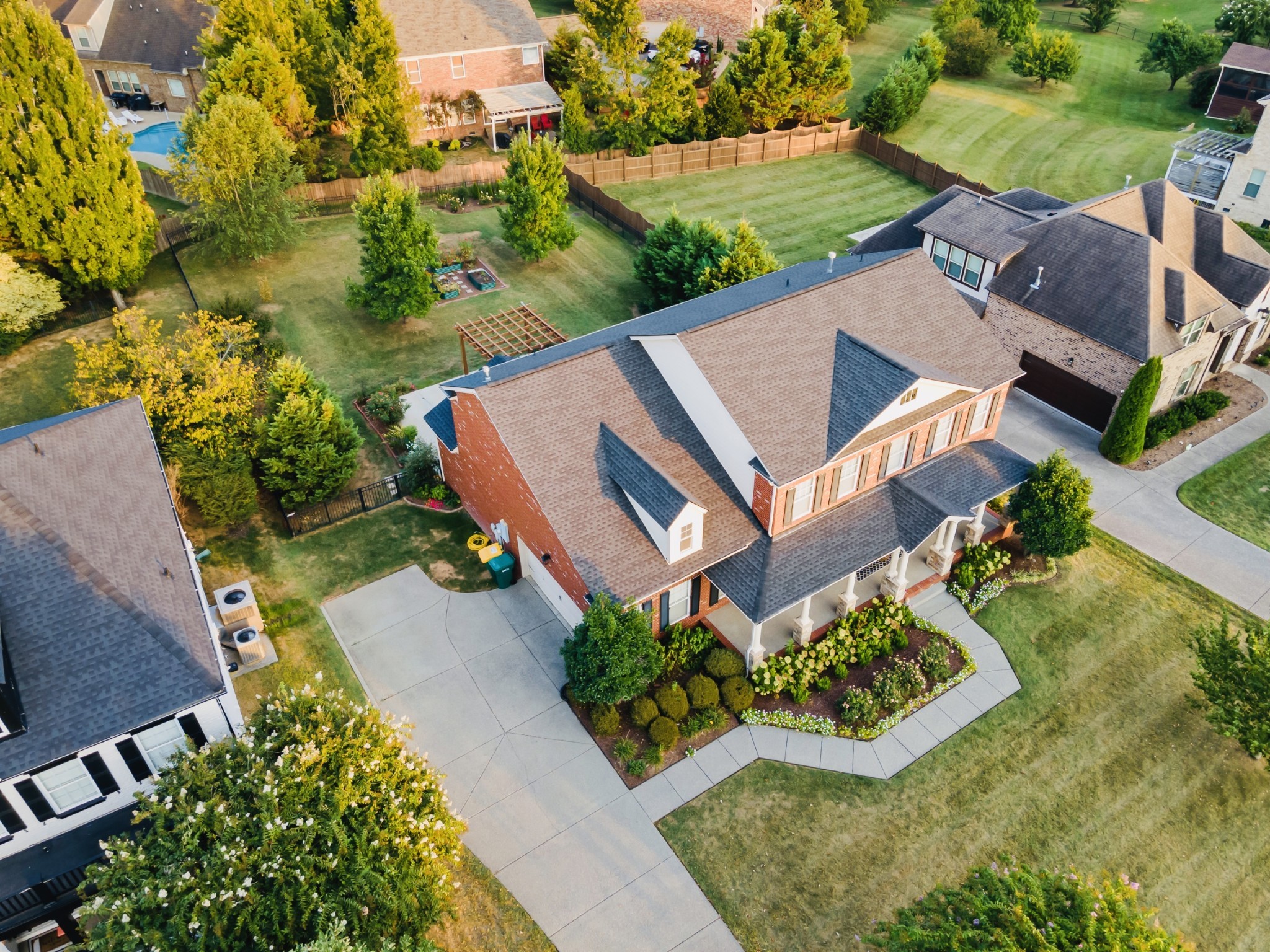 an aerial view of a house with garden space and street view