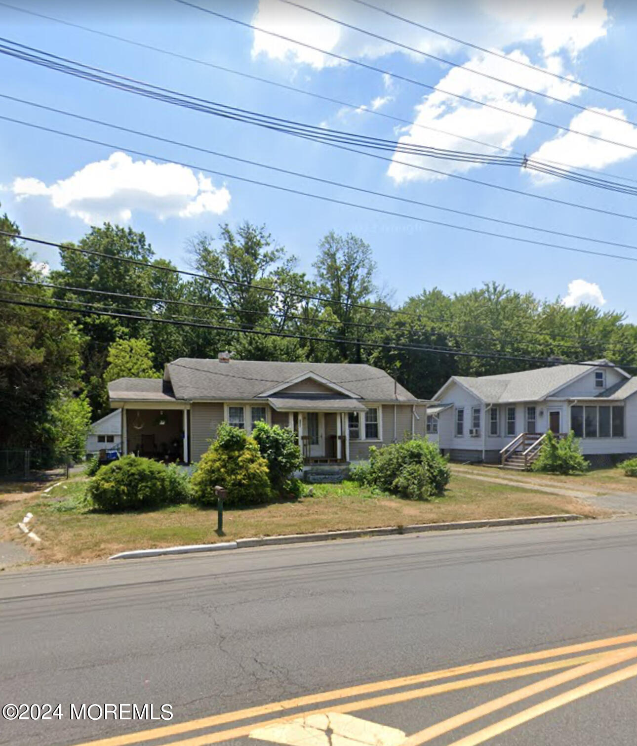 a front view of residential houses with yard and green space