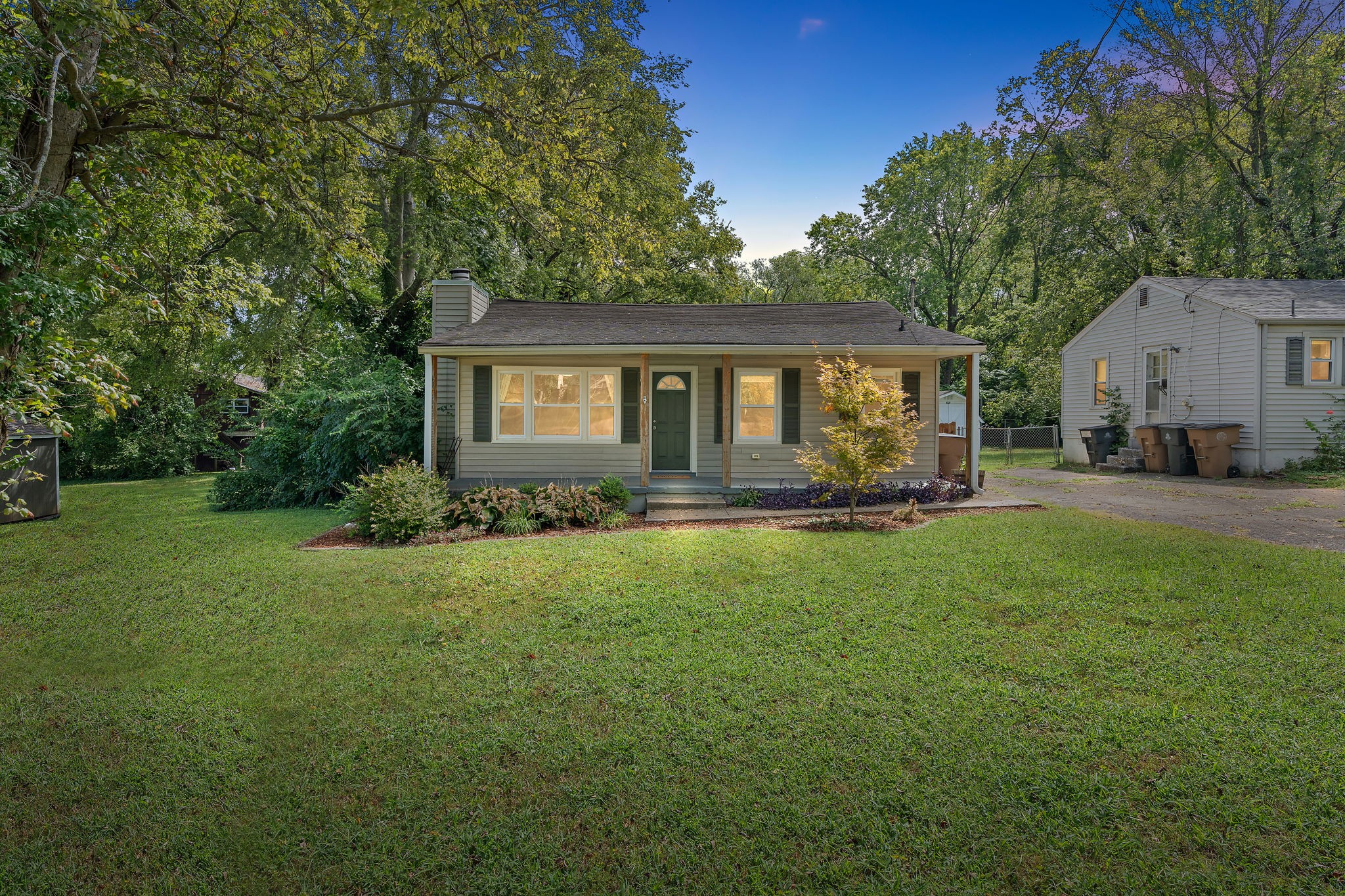 a front view of house with yard and green space