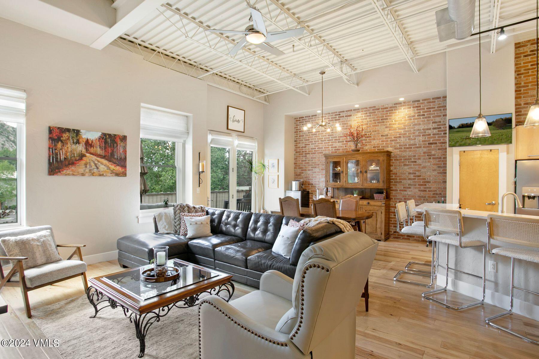 a living room with furniture and a floor to ceiling window