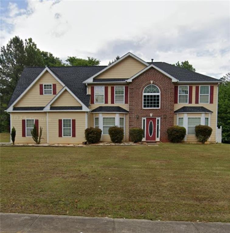 a front view of a house with a garden