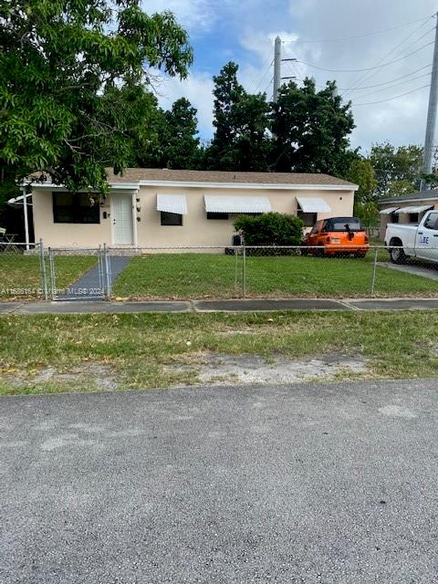 a front view of a house with a yard and a garage