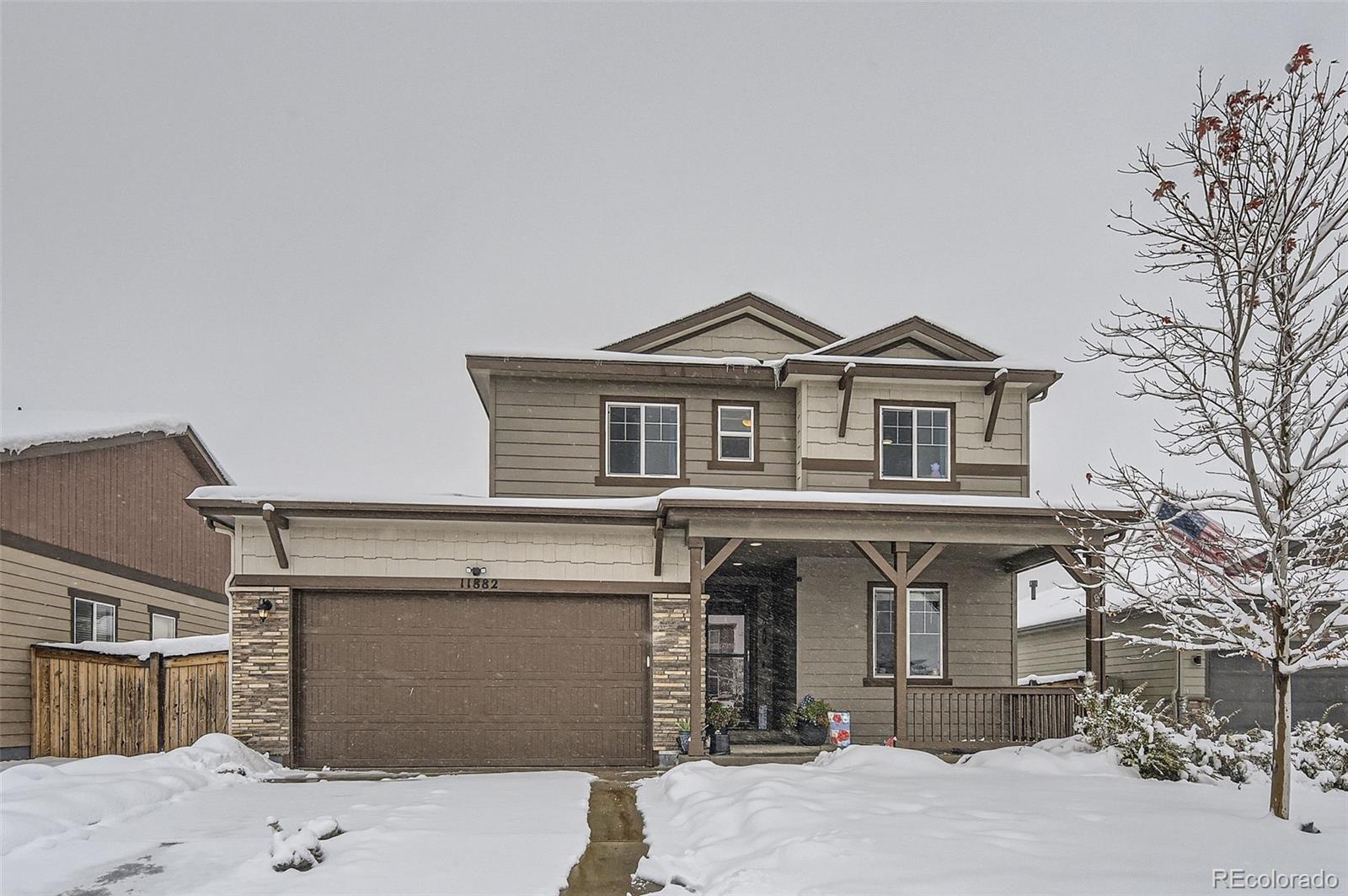 a front view of a house with yard and parking