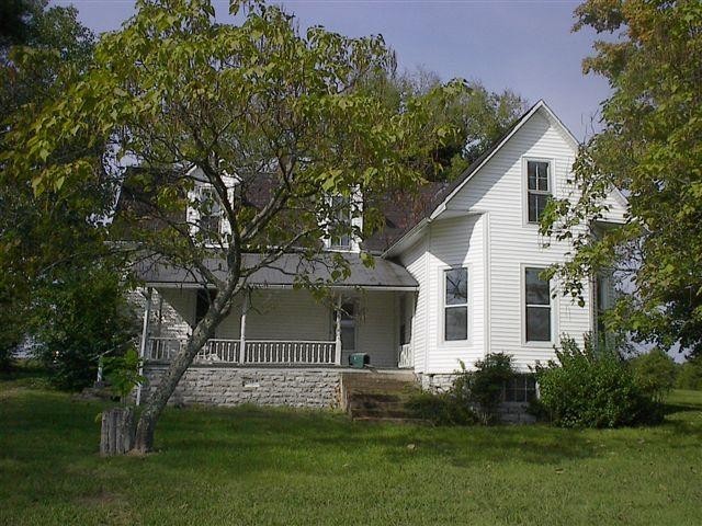 a front view of a house with a garden and yard