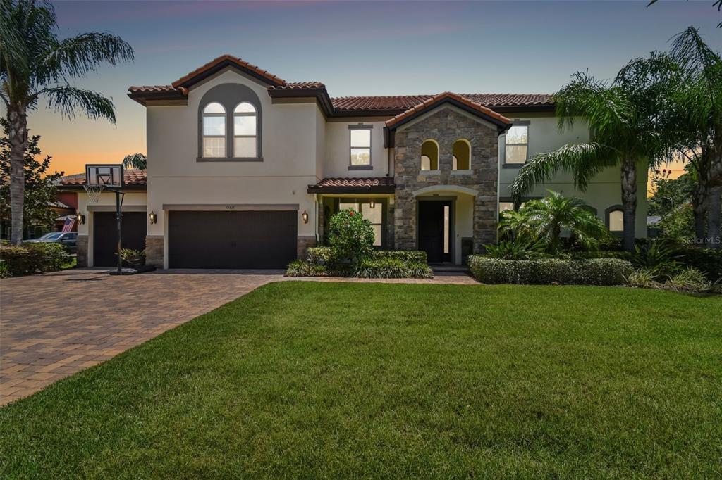 a front view of a house with a garden and yard