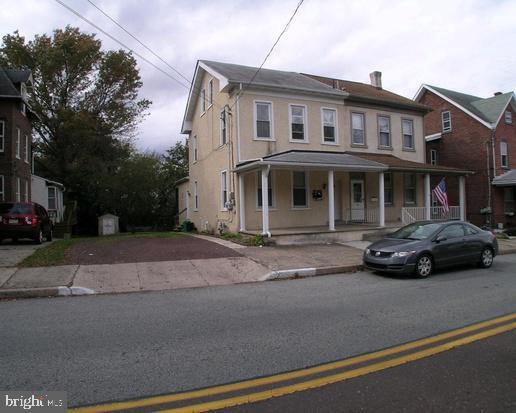 a couple of cars parked in front of a house