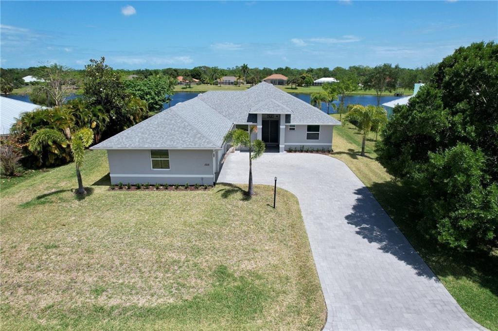 an aerial view of a house with a yard