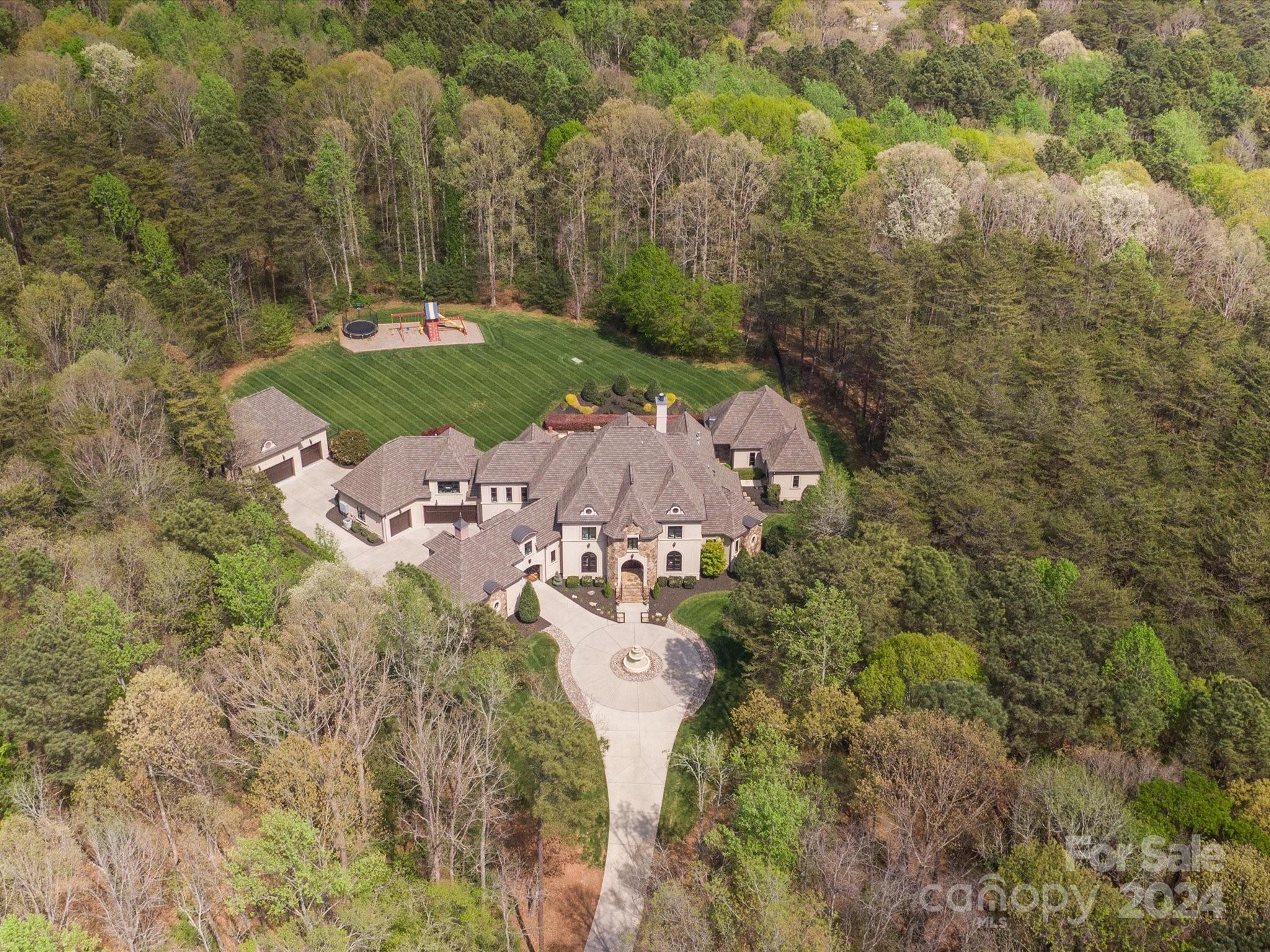 a aerial view of a house with yard and outdoor seating